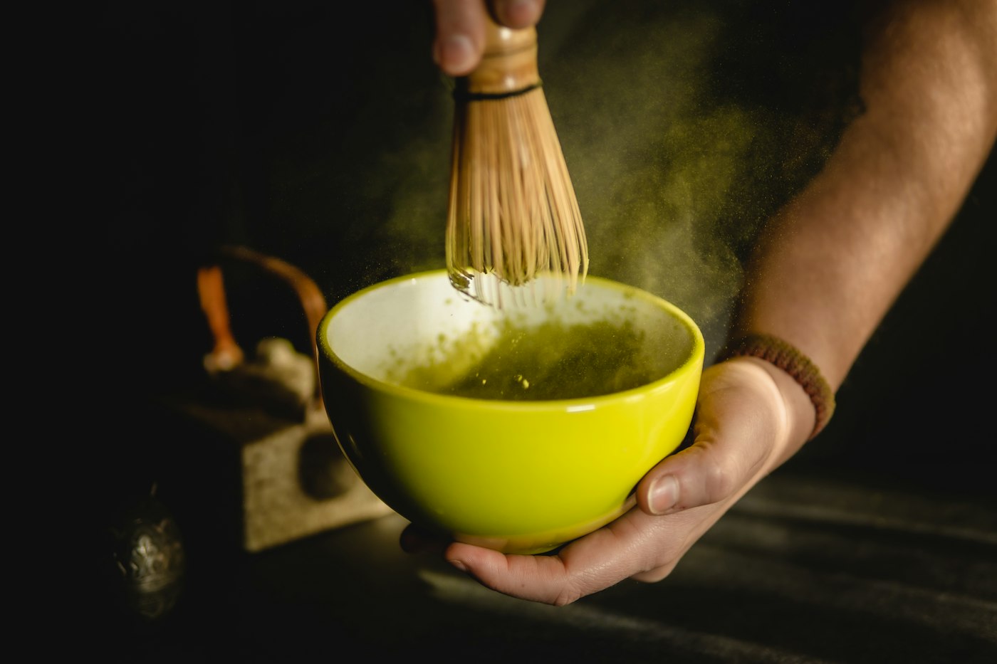Matcha being whisked in a ceramic bowl